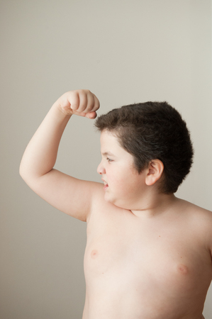 bad fat boy  shows his biceps  musclesの写真素材