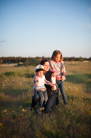 mother with children on a meadow near the forestの写真素材