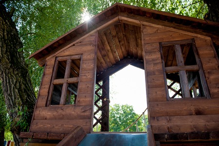 wooden house with windows on the tree on the playgroundの写真素材