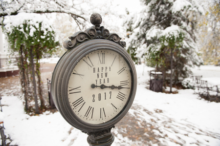 vintage clock with title Happy New Year 2017 on snowy streetの写真素材