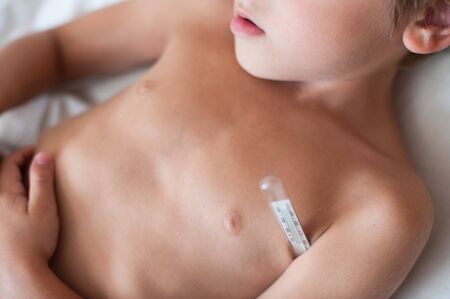 armpit of little kid with thermometer with temperatureの写真素材