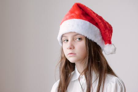 charming little girl in Santa hat dreamingの写真素材