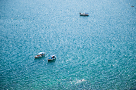 beautiful seascape with three boats with peopleの写真素材