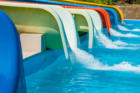 many water slides in amusement water park and blue summer poolの写真素材