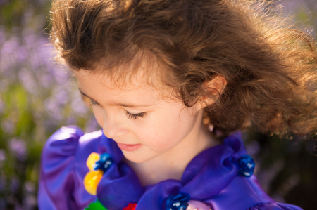 beautiful little girl with closed eyes and curly hair happy dreamingの写真素材