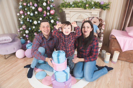 happy young family caucasian mother father and child in new year christmas decorationsの写真素材