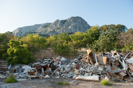 garbage lying outdoors in green park on rock mountain backgroundの写真素材