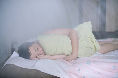 sleeping little caucasian relaxing thick child lying with green pillow during deep sleep in morning...