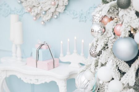 merry christmas eve holiday decoration indoors with table candles and Xmas tree with toysの写真素材