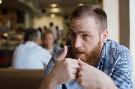 people in cafe bearded man during emotional discussion talkの写真素材