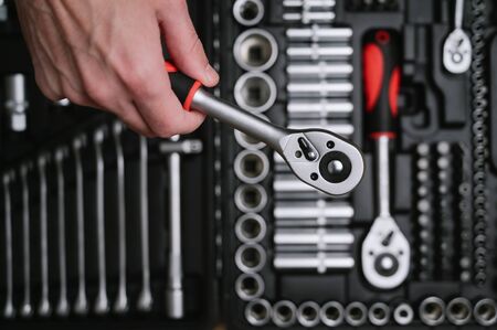 human hand with car repair tool on tool box kit backgroundの写真素材