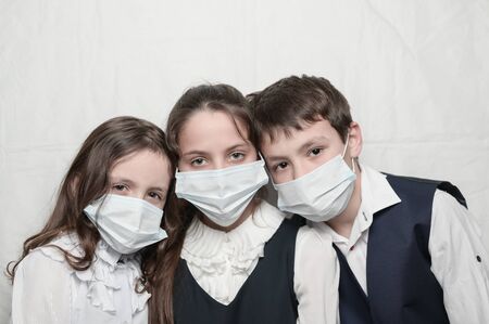 quarantine coronavirus covid-19 epidemic outbreak health care medicine concept of family children in school uniform wearing medical masks with copy spaceの写真素材