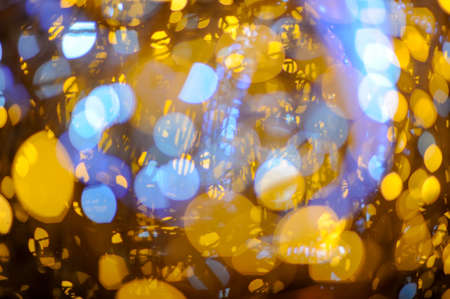 beautiful bright yellow and blue garland light during merry christmas eve night on city street with copy spaceの写真素材