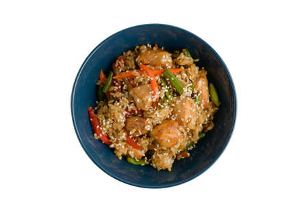 serving of fried chiken with rise and vegetable on deep blue dish on white isolated background with copyspaceの写真素材