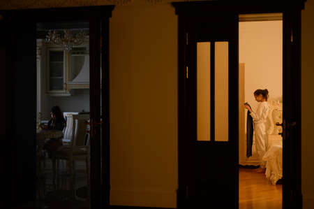 family of two little girls kids sister in bedroom and kitchen during casual domestic actionsの写真素材