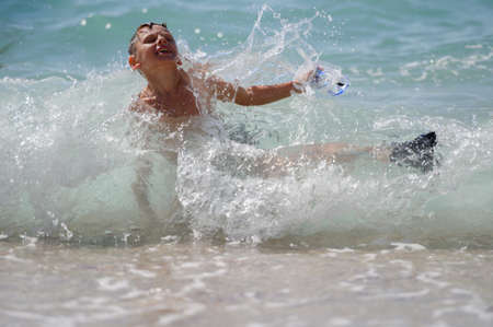 kid with diving mask and flippers falling in sea water splash during summer outdoors leisure activity holidayの写真素材