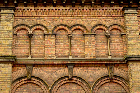 Red brick wall with arched window pattern and columnsの写真素材