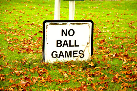 Close-up of No Ball Games sign on lawnの写真素材