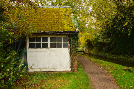 Old Mossy Canal Cottage Beside Bridge in English Countrysideの写真素材
