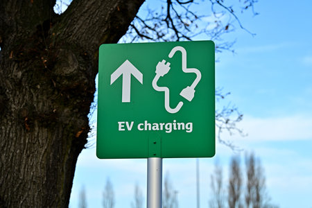 EV Charging Direction Sign with Plug Icon and Arrowの写真素材