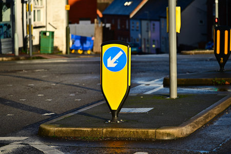Urban intersection keep-left sign on traffic island