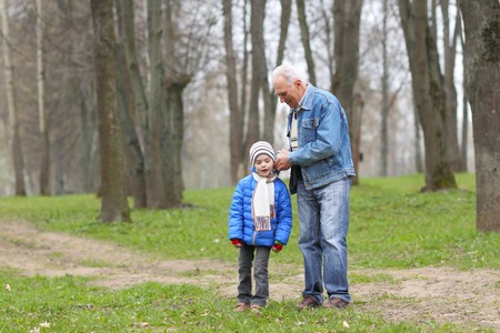 Grandfather and grandson study time on the old clockの写真素材