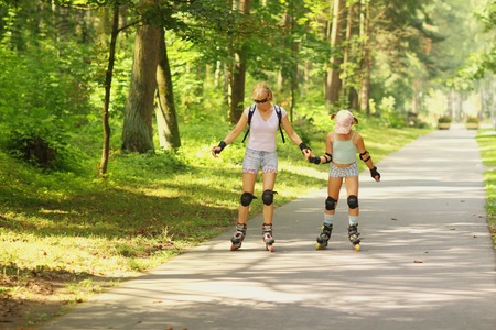 mother and daughter rollerbladingの写真素材