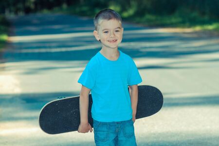 little boy having fun with skateboard outdoors.の写真素材