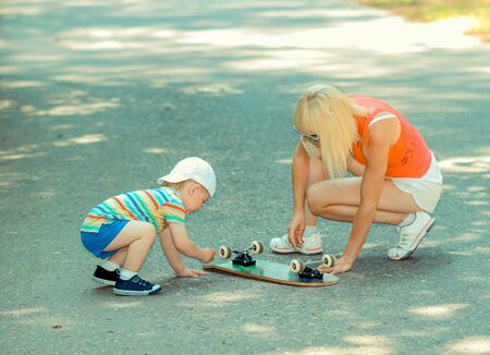 little boy with his mother repairing boardの写真素材