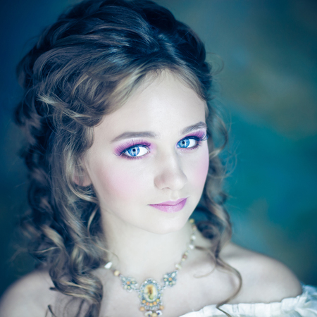 Little girl with beautiful makeup. Little girl in a vintage dress. portrait of a little princessの写真素材