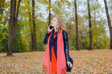 Modern hipster girl emotionally speaks on the phoneの写真素材