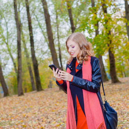 Modern hipster girl emotionally speaks on the phoneの写真素材