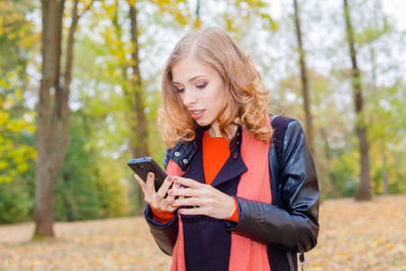 Modern hipster girl emotionally speaks on the phoneの写真素材