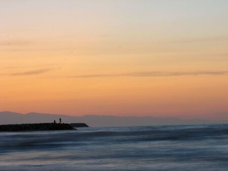 Sunset sky abstract background. Yellow sunset sky over the sea. Golden time of sky at sunset - sunrise time in summer season. Warm color sky  yellow. White space for text.の写真素材