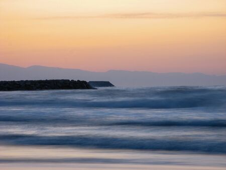Sunset sky abstract background. Yellow sunset sky over the sea. Golden time of sky at sunset - sunrise time in summer season. Warm color sky  yellow. White space for text.の写真素材