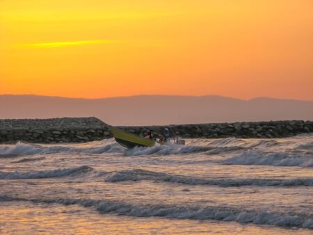 boat in sea Sunset . Yellow sunset sky over the sea. Golden time of sky at sunset - sunrise time in summer season. Warm color sky  yellow. White space for text.の写真素材