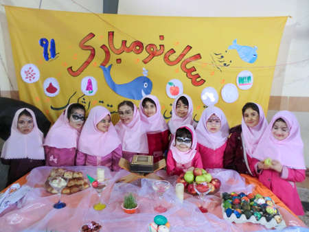 Rasht, Gilan, Iran, 05 05 2019. New Year Celebration at Girls' School in Iran. Nowruz table party with female students. Painted faces of students at the celebration.のeditorial素材
