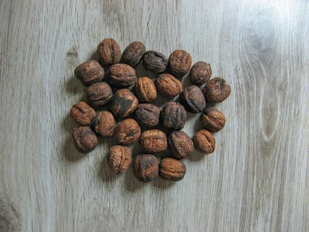 Forest walnut  on wooden background. Healthy nut food for brain. Close up view of fresh walnuts. Ripe walnut kernels.の写真素材