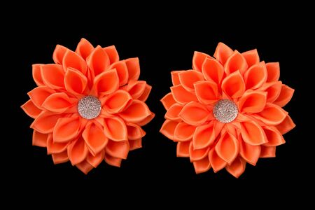 Handmade orange bows of satin ribbon and rhinestones.の写真素材