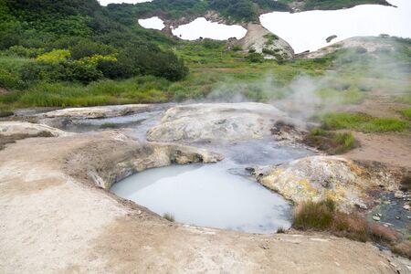 Small Valley of Geysers, Kamchatka Peninsula, Russia. This is a unique active fumarole field, the hot gases of which pass through the water of a cold stream, heating it and creating a gushing effect.の写真素材