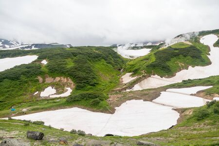 Small Valley of Geysers, Kamchatka Peninsula, Russia. This is a unique active fumarole field, the hot gases of which pass through the water of a cold stream, heating it and creating a gushing effect.の写真素材