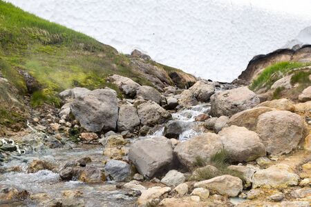 Small Valley of Geysers, Kamchatka Peninsula, Russia. This is a unique active fumarole field, the hot gases of which pass through the water of a cold stream, heating it and creating a gushing effect.の写真素材