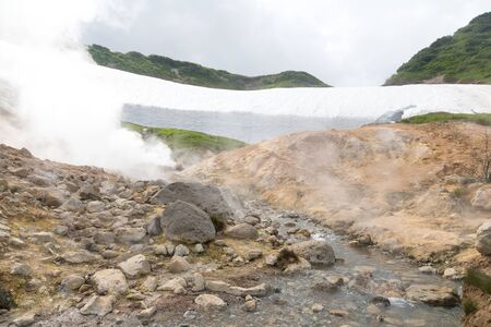 Small Valley of Geysers, Kamchatka Peninsula, Russia. This is a unique active fumarole field, the hot gases of which pass through the water of a cold stream, heating it and creating a gushing effect.の写真素材