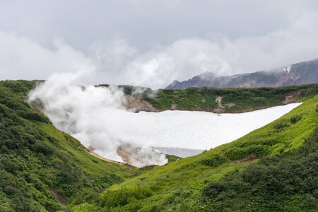 Small Valley of Geysers, Kamchatka Peninsula, Russia. This is a unique active fumarole field, the hot gases of which pass through the water of a cold stream, heating it and creating a gushing effect.の写真素材