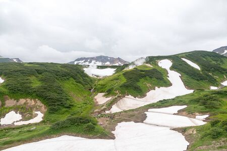 Small Valley of Geysers, Kamchatka Peninsula, Russia. This is a unique active fumarole field, the hot gases of which pass through the water of a cold stream, heating it and creating a gushing effect.の写真素材