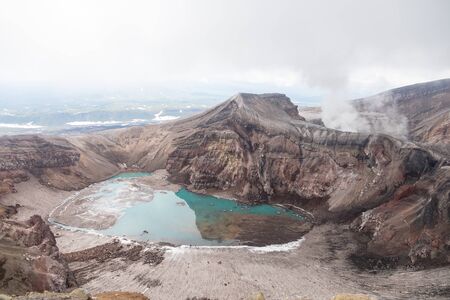 Gorely Volcano, Kamchatka Peninsula, Russia. An active volcano located in the south of Kamchatka. It consists of 11 cones and about 30 craters. Some craters are filled with acid or fresh water.の写真素材