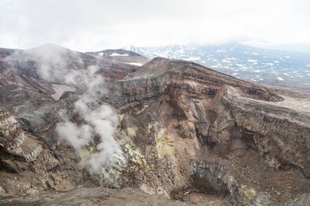 Gorely Volcano, Kamchatka Peninsula, Russia. An active volcano located in the south of Kamchatka. It consists of 11 cones and about 30 craters. Some craters are filled with acid or fresh water.の写真素材