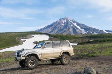 KAMCHATKA PENINSULA, RUSSIA - AUGUST 08, 2018: Toyota Land Cruiser off-road vehicle on a background of a volcanoのeditorial素材