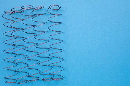Independent mattress springs on the table. Top view with copy space, flat layの写真素材