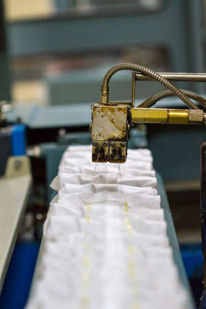 Production of independent springs for mattresses. Independent spring blocks packed in spunbond. Bonding layers of springs. Furniture manufacture. Industrial and business concept.の写真素材
